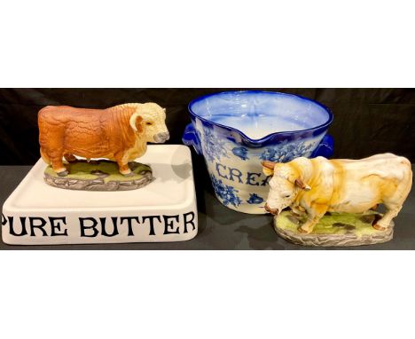Interior Decoration - a two handled blue and white cream crock; a shop display butter stand; a ceramic model of a bull; anoth