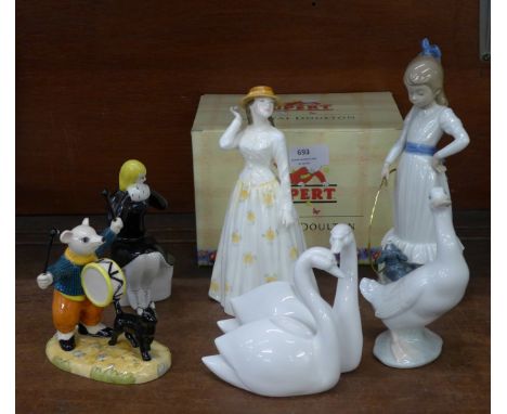 Six figures; Royal Doulton Susannah, Royal Doulton Rupert Characters Banging on His Drum, two Nao, Coalport swans and a USSR 