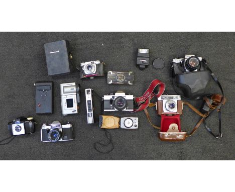 A box of cameras including Kodak, 35mm Praktica and a light meter 