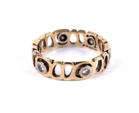 A diamond eternity ring, of pierced design, in 18ct yellow gold, size L 1/2, 3.1g gross.