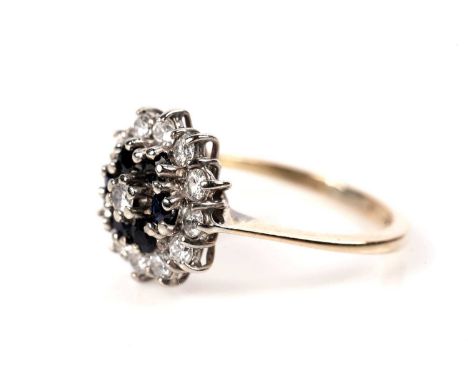 A sapphire and diamond cluster ring, set with a central brilliant-cut diamonds surrounded by six circular facet-cut sapphires