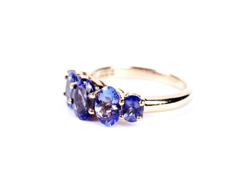 A tanzanite five stone dress ring, in 18ct yellow gold, size N, 4.6g gross, with AnchorCert Gemstone report. 