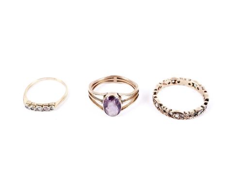 A diamond five stone ring, in platinum setting and gold mount, marks worn, size N; a white gemstone set eternity ring, stampe