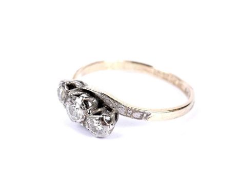 A diamond three stone ring, in platinum twist setting and 18ct yellow gold shank, size P, 2.6g gross.