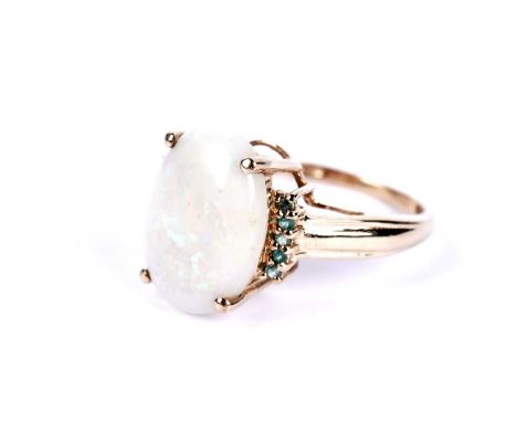 An opal and blue stone dress ring, stamped '10K', size O, 3.1g gross.