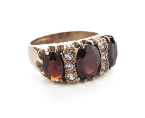 A garnet and white stone dress ring, in 9ct yellow gold, size K 1/2, 4.7g gross.