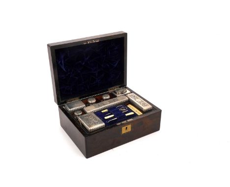 A George IV rosewood toilet box fitted with: four silver mounted cut-glass boxes, two silver mounted toilet bottles, another 