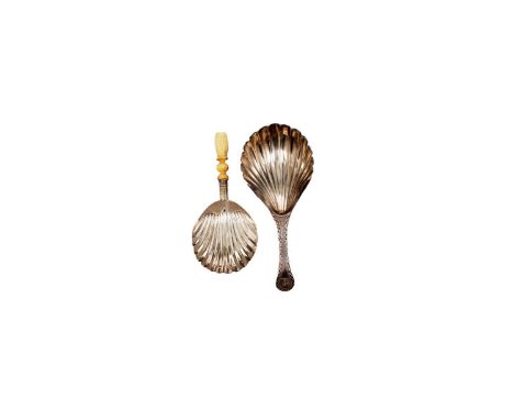 A George III silver caddy spoon with a fluted bowl and a bright-cut stem, crested, by William Barrett, London C.1780; and a s