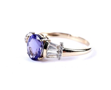 A tanzanite dress ring, with white sapphire set shoulders, in yellow gold, stamped '585', size R 1/2, 3.1g gross.