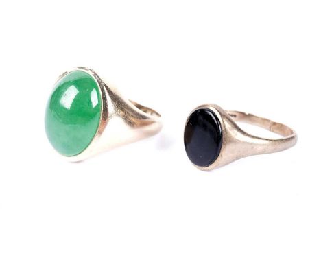 An onyx signet ring, in 9ct yellow gold, size R; and a jadeite cabochon signet ring, in yellow gold, stamped '14K', size S, 1