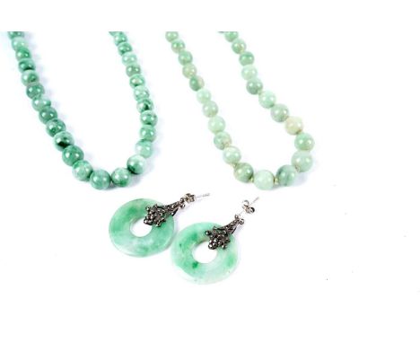 A pair of Art Deco style jadeite, marcasite and silver drop earrings; together with two nephrite jade bead necklaces, each wi