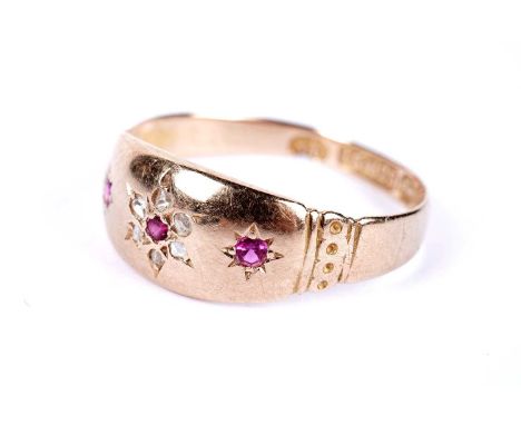 A Victorian ruby and diamond band, with flower motif decoration, in 15ct yellow gold, size P, 1.8g gross.