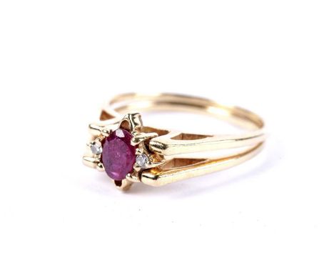 A ruby and diamond cluster swivel ring, with reversible diamond bezel, stamped '750', size P, 4.5g gross.