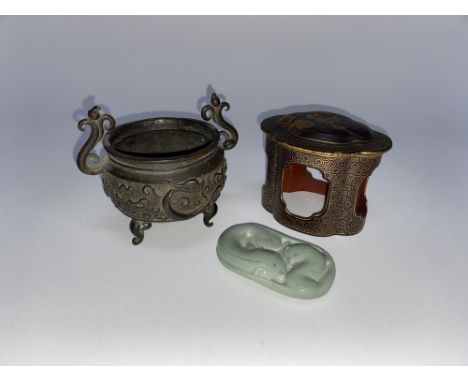 A small Oriental lacquered pot, a small decorative bronze cauldron decorated with dragons and a Chinese porcelain celadon obl