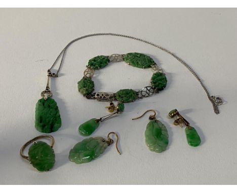 A collection of jade jewellery set in white gold to include bracelet, ring, pendant and two pairs of earrings
