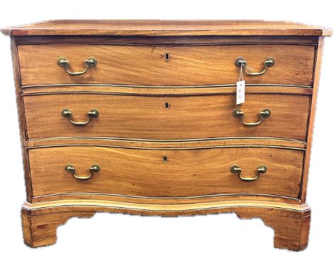 Georgian chest of drawers, the shaped surface above three brass handled serpentine drawers, raised on bracket feet [72cm x 95