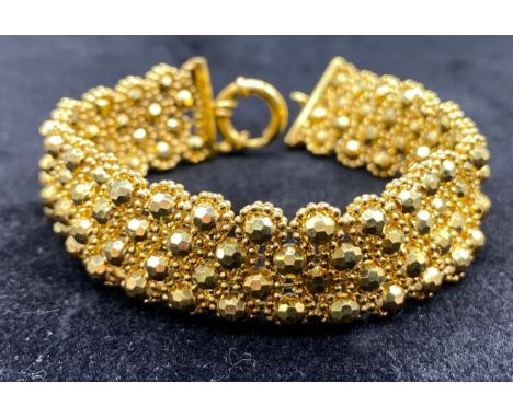 A Modern bracelet of facetted ball links, ring clasp indistinctly marked [9k, Italy] [Length 17cm 16mm broad] [weight 21.6g]