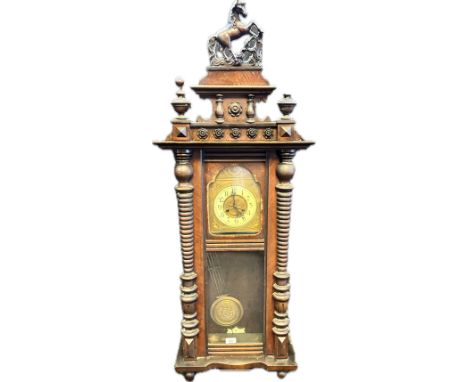 19th century mahogany cased wall clock, the gilt metal face with enamel ring and with centre bird design, flanked by turned c