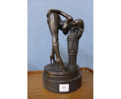 A bronze figure of an erotic female nude, on black marble socle