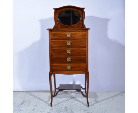 Edwardian mahogany music cabinet, raised back with oval bevelled mirror, fitted with five drawers, each with fall fronts, cab