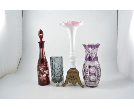 A ruby cased glass decanter, 38cm, an amethyst cased glass vase 28cm, an art nouveau trumpet shaped vase in pink and white wi