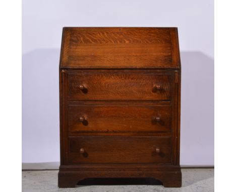 Oak bureau, fall front enclosing a part fitted interior, three long drawers below, on bracket feet, width 77cm.