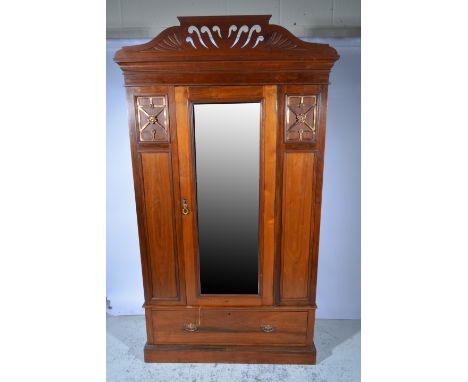 Edwardian walnut wardrobe, carved and fretted pediment, cavetto moulded cornice, plain frieze, central mirrored door flanked 