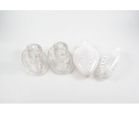 A pair of Victorian clear moulded glass lions with lozenge registration marks, two Nailsea type glass flask with white swirl 