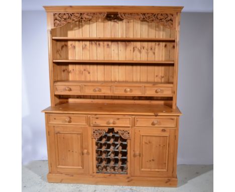 Modern pine dresser, three shelf delft rack incorporating four drawers, the base with drawers and cupboards surrounding an op