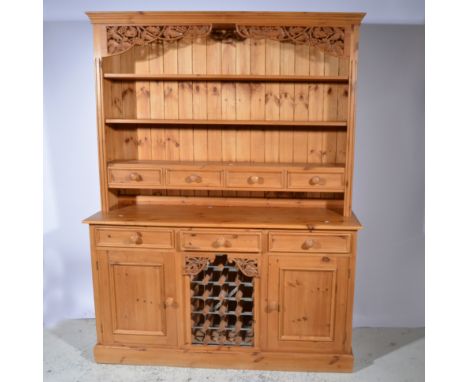 Modern pine dresser, three shelf delft rack incorporating four drawers, the base with drawers and cupboards surrounding an op