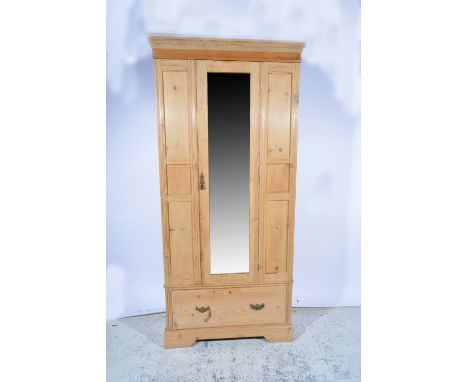 Stripped pine wardrobe, mirror panelled door, single drawer under, width 98cm, height 207cm.