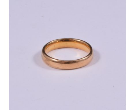 A 4mm wide wedding band, valuation states testing as 18/22ct, approximate weight 5.1gms, ring size L1/2, a small diamond set 
