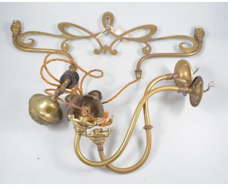 Three brass wall lights with glass shades and a twin arm rise and fall centre light fitting with shades.