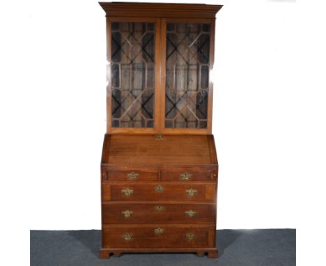 George III oak bureau bookcase, moulded cornice above a plain frieze, upper section with astragal glazed doors, enclosing thr