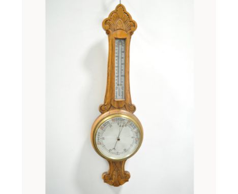 Edwardian carved oak aneroid barometer with thermometer over, patent 16538, 85cm.