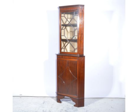 Edwardian mahogany free-standing corner cabinet, moulded cornice, plain frieze, astragal glazed door enclosing two shelves, c