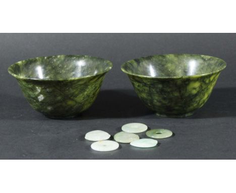 PAIR OF CHINESE SPINACH JADE BOWLS,  with flared rims, diameter 10cm; together with a collection of six jadeite pendants (8)