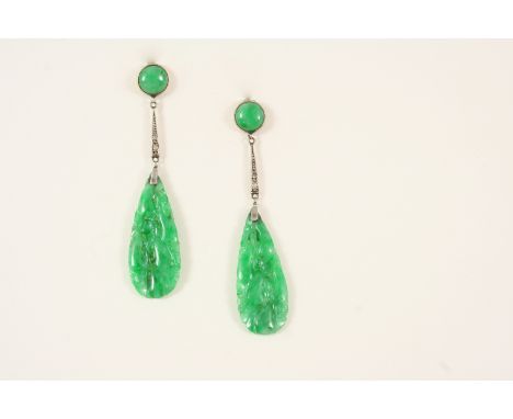 A PAIR OF JADE AND DIAMOND DROP EARRINGS each formed with a pear-shaped pierced and carved section of jade suspended from two