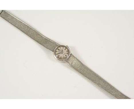 A LADY'S 9CT. WHITE GOLD WRISTWATCH BY ROTARY the signed circular dial with baton numerals, on an integrated granulated 9ct. 