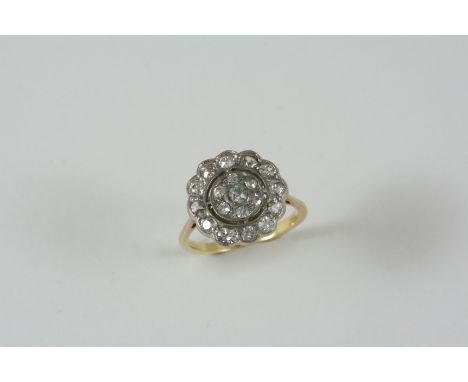 A DIAMOND CLUSTER RING set overall with graduated old brilliant-cut diamonds, in gold. Size K.