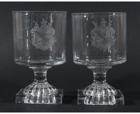 PAIR OF ENGLISH GLASS RUMMERS, circa 1800, the bucket bowls engraved with a coat of arms of three bull's heads, on a short st