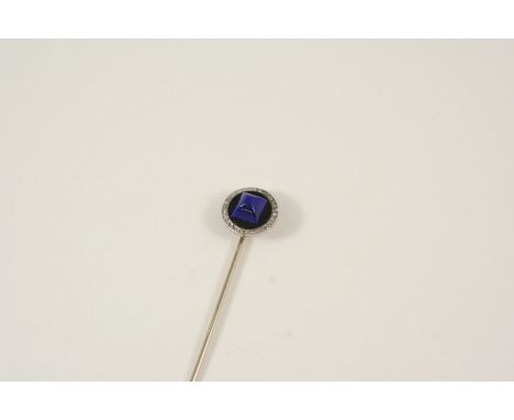 AN ART DECO DIAMOND, LAPIS LAZULI AND ONYX STICK PIN BY CARTIER the oval-shaped black onyx is centred with a square pyramid-s