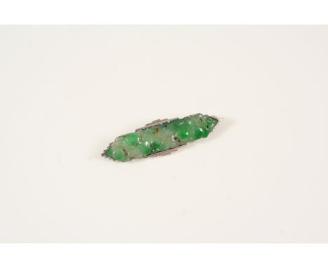 AN ART DECO JADE BROOCH set with a foliate carved and pierced section of jade, 5cm. long.