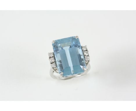 AN AQUAMARINE AND DIAMOND RING the step-cut aquamarine is set with three circular-cut diamonds to each shoulder. Size M.