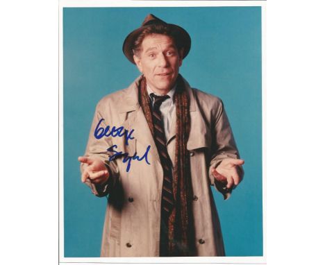 George Segal signed 10 x 8 colour photo in grey coat portrait. Good Condition. All signed items come with our certificate of 