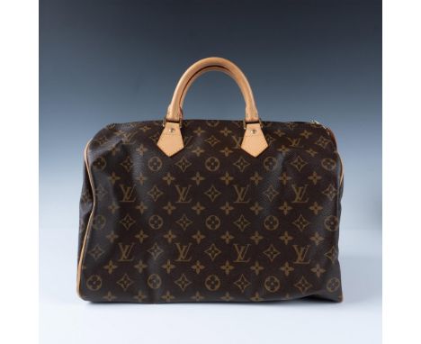 Leather trim and rolled leather handles. This timeless classic features the iconic monogram canvas, a spacious interior, and 