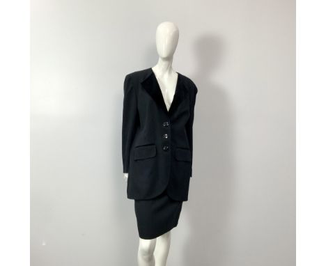 A vintage timeless black wool pencil skirt with a small slit and pleated detail on the back. Size: 42. Waist: 14"W. Full leng