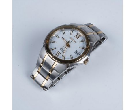 Two toned link wrist band with roman numerals and digital date window displayed on white face front. Solar and 100M mark on f