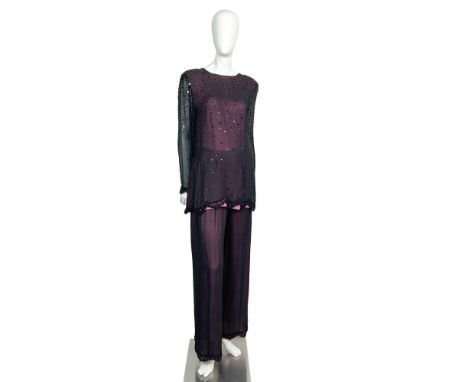 An exquisite vintage two-piece outfit, featuring a pink blouse elegantly draped with sheer black fabric, adorned with sequins