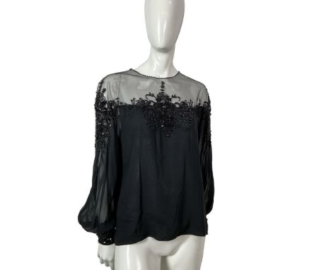 A chic long sleeved sheer black silk blouse intricately decorated with beads and sequins along the bust and sleeves. Size: 6.